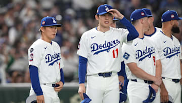 Mar 16, 2025; Bunkyo, Tokyo, Japan; Los Angeles Dodgers pitcher Yoshinobu Yamamoto (left) and pitcher Roki Sasaki (11) stand on the field before the game against the Hanshin Tigers at Tokyo Dome. Mandatory Credit: Darren Yamashita-Imagn Images