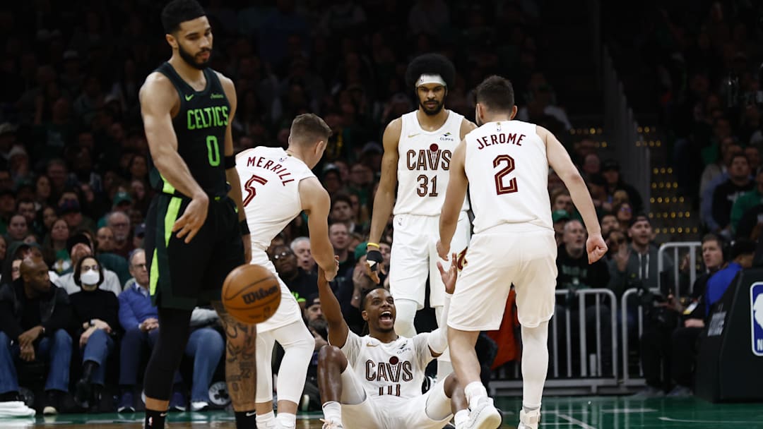 Feb 28, 2025; Boston, Massachusetts, USA; Cleveland Cavaliers guard Darius Garland (10) smiles as he is helped up by teammates after Boston Celtics forward Jayson Tatum (0) was called for an offensive foul during the second half at TD Garden. Mandatory Credit: Winslow Townson-Imagn Images