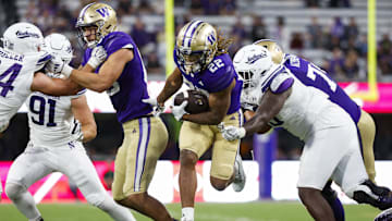Sep 21, 2024; Seattle, Washington, USA; Washington Huskies running back Cameron Davis (22) rushes against the Northwestern Wildcats during the fourth quarter at Alaska Airlines Field at Husky Stadium. Washington Huskies tight end Keleki Latu (85) blocks at left. Mandatory Credit: Joe Nicholson-Imagn Images