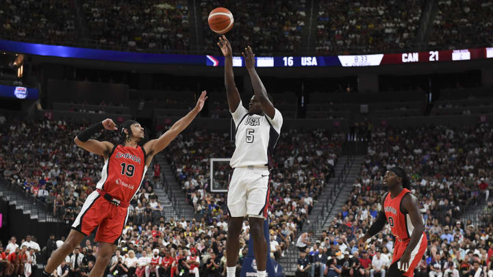 Jul 10, 2024; Las Vegas, Nevada, USA; USA guard Anthony Edwards (5) shoots over Canada guard Andrew Nembhard (19) in the second quarter of the USA Basketball Showcase at T-Mobile Arena.