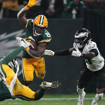 With a block by Dontayvion Wicks, Packers RB Josh Jacobs gets into the open field against the Eagles.