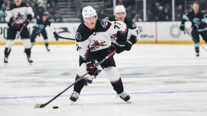Apr 6, 2023; Seattle, Washington, USA; Arizona Coyotes defenseman Victor Soderstrom (77) advances the puck against the Seattle Kraken during the first period at Climate Pledge Arena. Mandatory Credit: Steven Bisig-Imagn Images