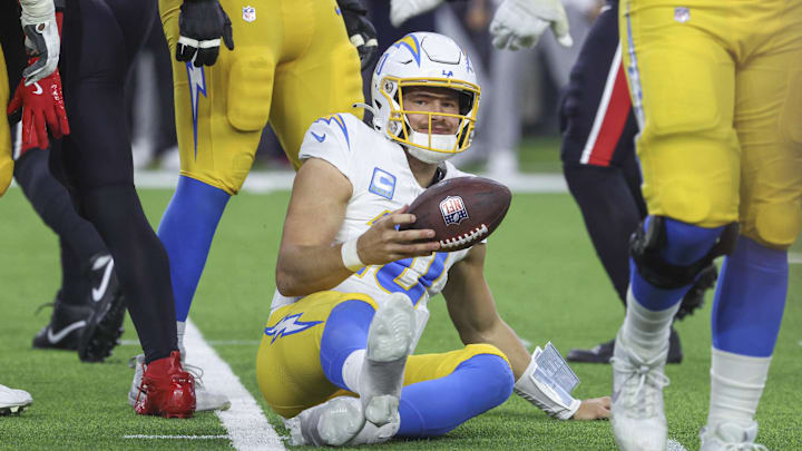 Jan 11, 2025; Houston, Texas, USA; Los Angeles Chargers quarterback Justin Herbert (10) reacts after being sacked during the game against the Houston Texans in an AFC wild card game at NRG Stadium. Mandatory Credit: Troy Taormina-Imagn Images