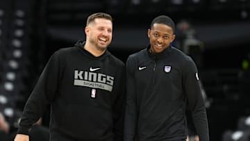 Nov 24, 2024; Sacramento, California, USA; Sacramento Kings guard De'Aaron Fox (right) and assistant coach Luke Loucks (left) talk before the game against the Brooklyn Nets at Golden 1 Center. Mandatory Credit: Darren Yamashita-Imagn Images