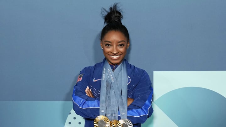 Simone Biles of the United States poses for a photo with her three gold and one silver medal after day three of the gymnastics event finals during the Paris 2024 Olympic Summer Games. 