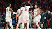 Houston guard Emanuel Sharp (21) congratulated by teammates