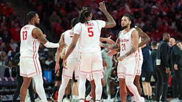 Houston guard Emanuel Sharp (21) congratulated by teammates