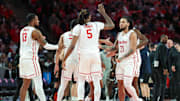 Houston guard Emanuel Sharp (21) congratulated by teammates