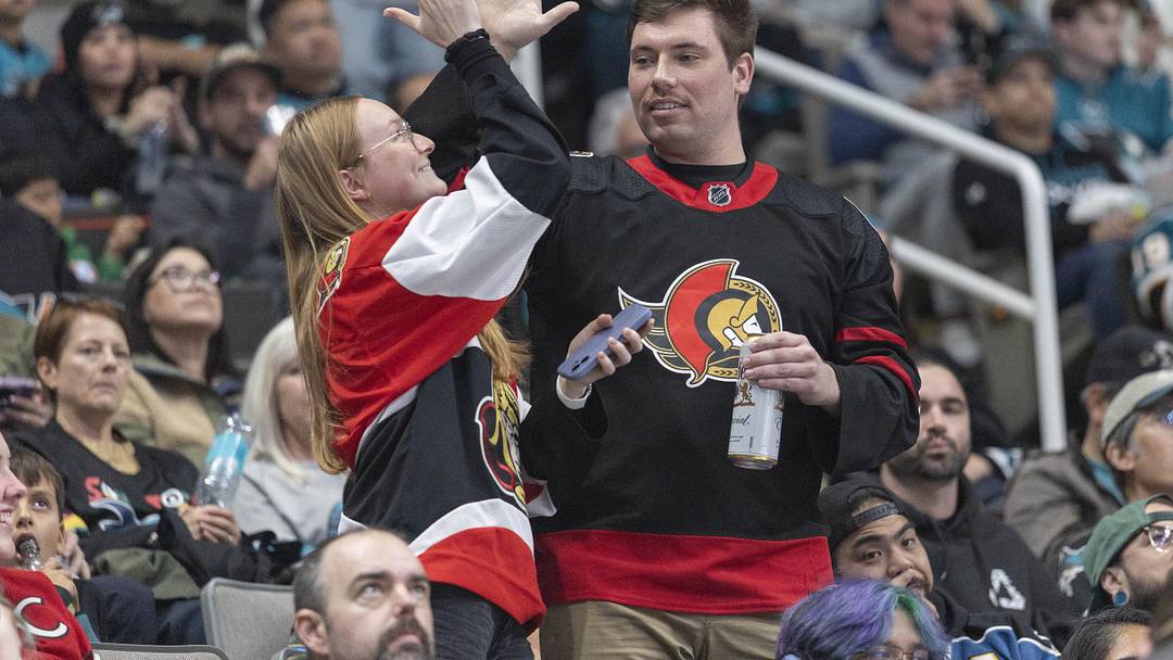 Nov 22, 2025; San Jose, California, USA;  Ottawa Senators fans celebrate after the team scored a goal during the second period against the San Jose Sharks at SAP Center at San Jose. Mandatory Credit: Stan Szeto-Imagn Images
