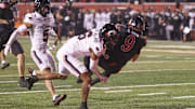 Nov 1, 2025; Salt Lake City, Utah, USA; Utah Utes wide receiver Ryan Davis (9) is tackled in the end zone for a touchdown by Cincinnati Bearcats defensive back Tre Gola-Callard (6) during the first quarter at Rice-Eccles Stadium. Mandatory Credit: Rob Gray-Imagn Images