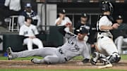 New York Yankees outfielder Cody Bellinger (35) slides safely past Chicago White Sox catcher Kyle Teel (8) at Rate Field. 