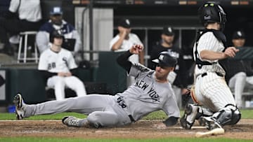 New York Yankees outfielder Cody Bellinger (35) slides safely past Chicago White Sox catcher Kyle Teel (8) at Rate Field. 