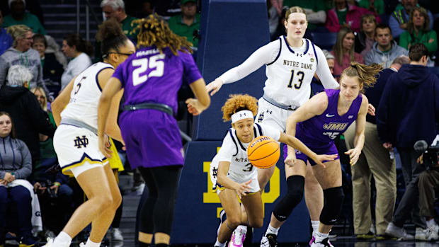 Notre Dame guard Hannah Hidalgo (3) and James Madison center Kseniia Kozlova (35) chase after a loose ball