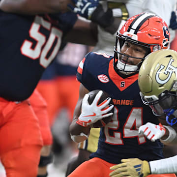 Sep 7, 2024; Syracuse, New York, USA; Syracuse Orange running back Will Nixon (24) is tackled by Georgia Tech Yellow Jackets defensive back Taye Seymore (7) in the third quarter at the JMA Wireless Dome. Mandatory Credit: Mark Konezny-Imagn Images