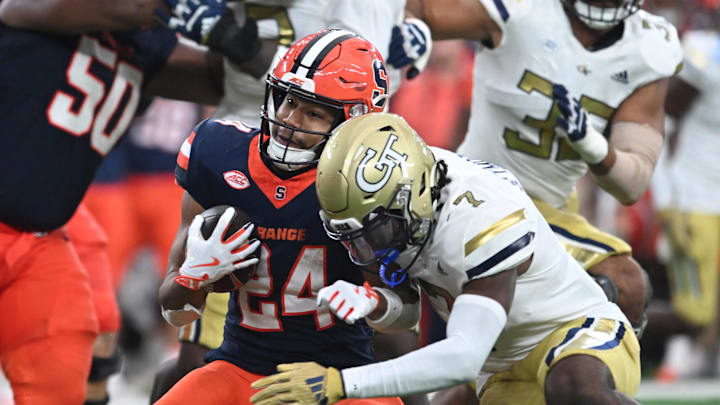 Sep 7, 2024; Syracuse, New York, USA; Syracuse Orange running back Will Nixon (24) is tackled by Georgia Tech Yellow Jackets defensive back Taye Seymore (7) in the third quarter at the JMA Wireless Dome. Mandatory Credit: Mark Konezny-Imagn Images