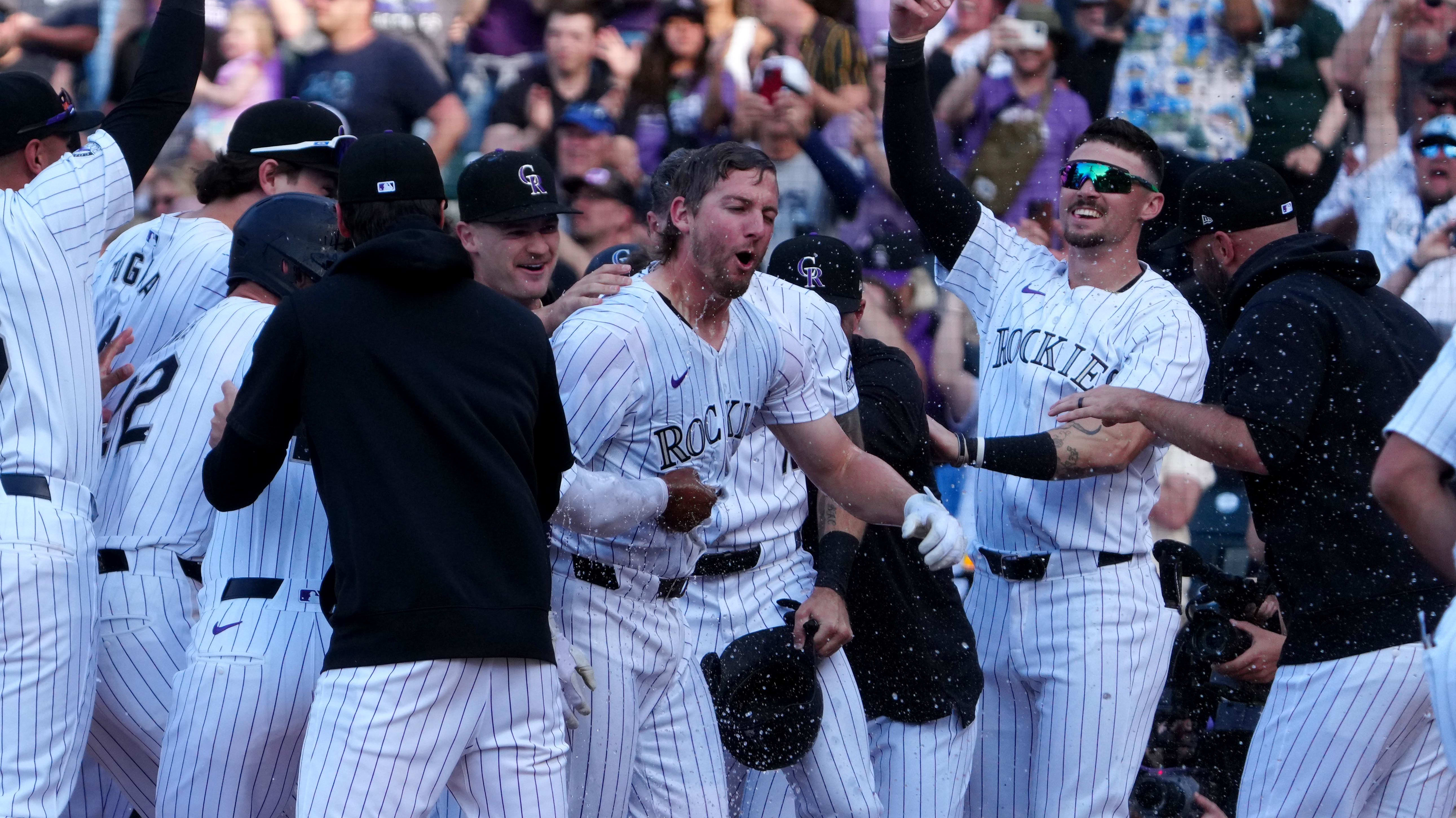 Apr 5, 2024; Denver, Colorado, USA; Colorado Rockies third base Ryan McMahon (24) celebrates his walk-off grand slam.