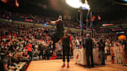 Jan 4, 2025; Miami, Florida, USA;  Miami Heat center Bam Adebayo, left, leaps into the air after warming-up with the help of center Kel'el Ware (7) before the game against the Utah Jazz at Kaseya Center. Mandatory Credit: Jim Rassol-Imagn Images