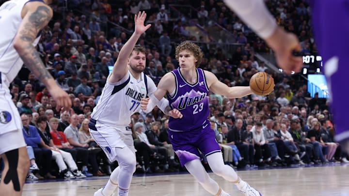 Mar 25, 2024; Salt Lake City, Utah, USA; Utah Jazz forward Lauri Markkanen (23) drives against Dallas Mavericks guard Luka Doncic (77) during the third quarter at Delta Center. Mandatory Credit: Rob Gray-Imagn Images