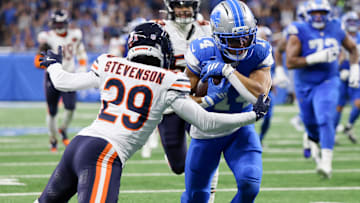 Detroit Lions wide receiver Amon-Ra St. Brown (14) carries the ball, defended by Chicago Bears cornerback Tyrique Stevenson (29) during the first quarter at Ford Field.