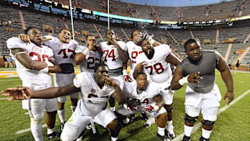 Oct 15, 2016; Knoxville, TN, USA;  Alabama Crimson Tide players celebrate their 49-10 victory with a traditional victory cigar after defeating the Tennessee Volunteers at Neyland Stadium. Mandatory Credit: John David Mercer-Imagn Images