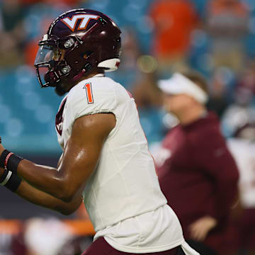 Sep 27, 2024; Virginia Tech quarterback Kyron Drones (1) warms up before the game against Miami at Hard Rock Stadium.