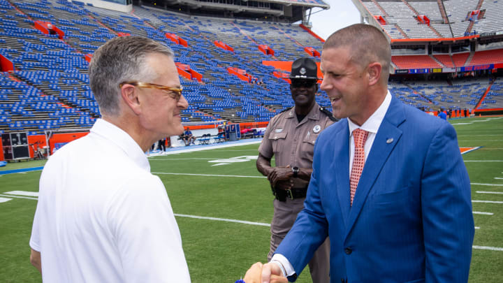 Florida Athletic Director Scott Strickland shakes hands with Florida Gators head coach Billy Napier during Gator Walk for the season opener vs. Miami.