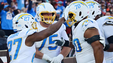 Nov 3, 2024; Cleveland, Ohio, USA; Los Angeles Chargers running back J.K. Dobbins (27) celebrates with offensive tackle Rashawn Slater (70) after scoring a touchdown during the first half against the Cleveland Browns at Huntington Bank Field.