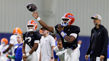Florida Gators quarterback DJ Lagway (2) throws the ball while Florida Gators assistant coach for quarterbacks Ryan O'Hara looks on during fall football practice at Sanders Indoor Practice Fields at the University of Florida in Gainesville, FL on Thursday, August 7, 2025. [Matt Pendleton/Gainesville Sun]