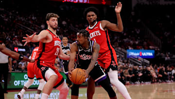 Dec 3, 2025; Houston, Texas, USA; Sacramento Kings guard Malik Monk (0) looks to pass to a teammate against Houston Rockets center Alperen Sengun (28) and Houston Rockets guard Amen Thompson (1) during the fourth quarter at Toyota Center. Mandatory Credit: Erik Williams-Imagn Images