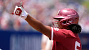 Oklahoma slugger Ella Parker celebrates after reaching base in the WCWS.