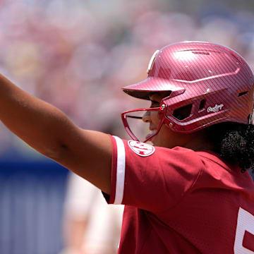 Oklahoma slugger Ella Parker celebrates after reaching base in the WCWS.