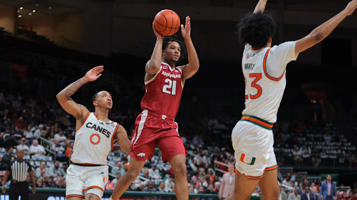 Dec 3, 2024; Coral Gables, Florida, USA; Arkansas Razorbacks guard D.J. Wagner (21) passes the basketball against the Miami Hurricanes during the first half at Watsco Center. Mandatory Credit: Sam Navarro-Imagn Images