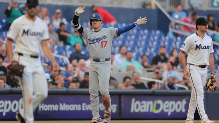 Los Angeles Dodgers designated hitter Shohei Ohtani (17) reacts from third base after hitting a triple against the Miami Marlins during the sixth inning at loanDepot Park. Los Angeles Dodgers designated hitter Shohei Ohtani (17) reacts from third base after hitting a triple against the Miami Marlins during the sixth inning at loanDepot Park.