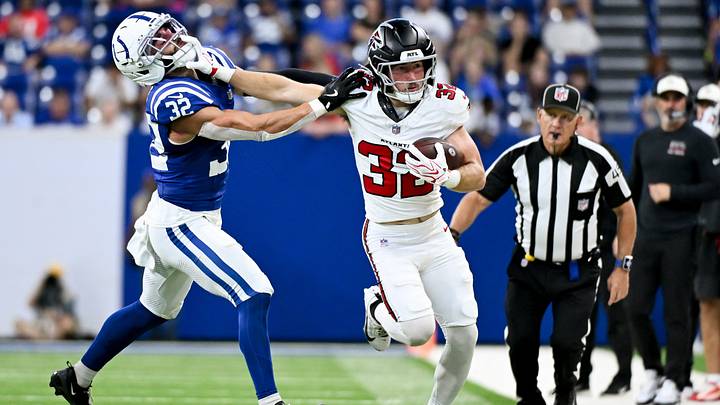 Aug 22, 2026; Indianapolis, Indiana, USA; Atlanta Falcons running back Cash Jones (32) stiff arms Indianapolis Colts safety Daniel Scott (32) during the second half at Lucas Oil Stadium. Mandatory Credit: Robert Goddin-Imagn Images