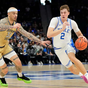 Mar 13, 2025; Charlotte, NC, USA; Duke Blue Devils forward Cooper Flagg (2) with the ball as Georgia Tech Yellow Jackets forward Duncan Powell (31) defends in the first half at Spectrum Center. Mandatory Credit: Bob Donnan-Imagn Images