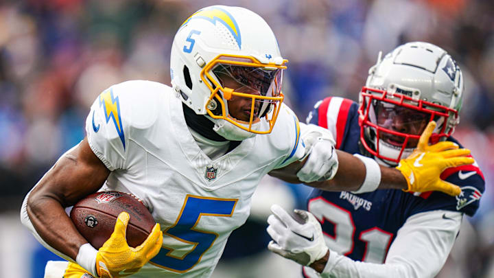 Dec 28, 2024; Foxborough, Massachusetts, USA; Los Angeles Chargers wide receiver Joshua Palmer (5) runs the ball against New England Patriots cornerback Jonathan Jones (31) in the first quarter at Gillette Stadium. 