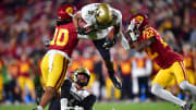 Nov 11, 2022; Los Angeles, California, USA; Colorado Buffaloes running back Alex Fontenot (8) is brought down by Southern California Trojans linebacker Ralen Goforth (10) and defensive back Ceyair Wright (22) during the first half at the Los Angeles Memorial Coliseum.