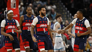 Dec 26, 2024; Washington, District of Columbia, USA; Washington Wizards forward Justin Champagnie (9) celebrates with Wizards guard Bub Carrington (8) during a timeout in the final seconds against the Charlotte Hornets in the fourth quarter at Capital One Arena. Mandatory Credit: Geoff Burke-Imagn Images