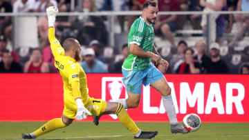 Jul 9, 2024; Sacramento, California, USA; Seattle Sounders forward Jordan Morris (right) dribbles against Sacramento Republic FC goalkeeper Danny Vitiello (left) during the first half at Heart Health Park. Mandatory Credit: Darren Yamashita-USA TODAY Sports