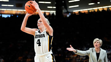 Iowa Hawkeyes guard Kylie Feuerbach (4) attempts a three-point basket against the Purdue Boilermakers Sunday, Dec. 29, 2024 at Carver-Hawkeye Arena in Iowa City, Iowa.