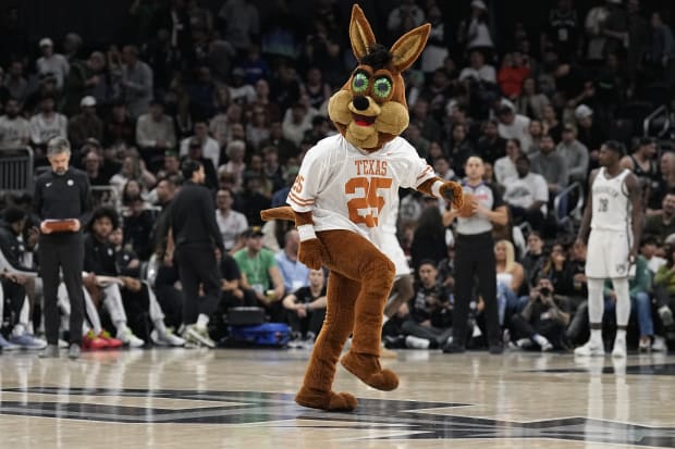 The San Antonio Spurs Coyote wears a Texas Longhorns jersey while performing during the second half against the Brooklyn Nets