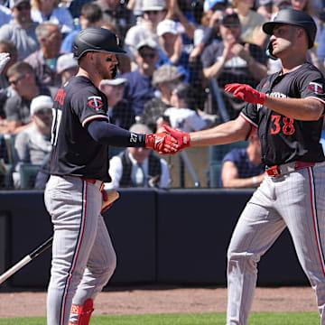 Mar 6, 2025; Tampa, Florida, USA; Minnesota Twins outfielder Matt Wallner (38) is congratulated at the plate by catcher Ryan Jeffers (27) as New York Yankees catcher Austin Wells (28) walks away during the second inning at George M. Steinbrenner Field.
