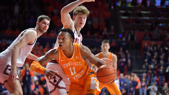 Dec 14, 2024; Champaign, Illinois, USA;  Tennessee Volunteers guard Jordan Gainey (11) drives the ball past Illinois Fighting Illini guard Kasparas Jakucionis (32) during the second half at State Farm Center. Mandatory Credit: Ron Johnson-Imagn Images