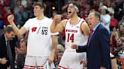 Feb 13, 2024; Madison, Wisconsin, USA;  Wisconsin Badgers forward Nolan Winter (31), forward Carter Gilmore (14) and head coach Greg Gard celebrate a three point basket during the second half against the Ohio State Buckeyes at the Kohl Center.