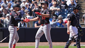 Minnesota Twins outfielder Matt Wallner (38) is congratulated at the plate by catcher Ryan Jeffers as New York Yankees catcher Austin Wells walks away during the second inning at George M. Steinbrenner Field in Tampa, Fla., on March 6, 2025.