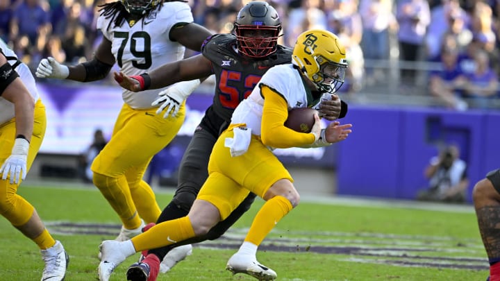 Nov 18, 2023; Fort Worth, Texas, USA; Baylor Bears quarterback Blake Shapen (12) is tackled by TCU Horned Frogs defensive lineman Damonic Williams (52) during the first half at Amon G. Carter Stadium. Mandatory Credit: Jerome Miron-USA TODAY Sports