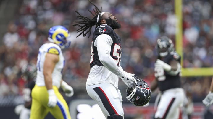 Aug 24, 2024; Houston, Texas, USA; Houston Texans defensive tackle McTelvin Agim (58) picks up his helmet after a play during the game against the Los Angeles Rams at NRG Stadium. Mandatory Credit: Troy Taormina-USA TODAY Sports