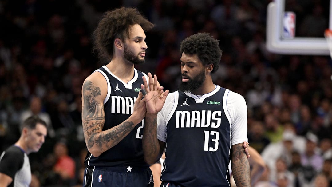 Nov 21, 2025; Dallas, Texas, USA; Dallas Mavericks forward Naji Marshall (13) is restrained by center Dereck Lively II (2) after Marshall receives a technical foul during the second half against the New Orleans Pelicans at the American Airlines Center. Mandatory Credit: Jerome Miron-Imagn Images