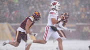 Nov 29, 2025; Minneapolis, Minnesota, USA; Wisconsin Badgers quarterback Carter Smith (5) runs with the ball against the Minnesota Golden Gophers during the first half at Huntington Bank Stadium.