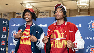 Adonis and Darius Ratliff, Archbishop Stepinac High School's 7-foot twins display their University of Southern California shirts and caps in the high school gym in White Plains Oct. 22, 2025, after announcing that they would be attending and playing basketball at USC next year.